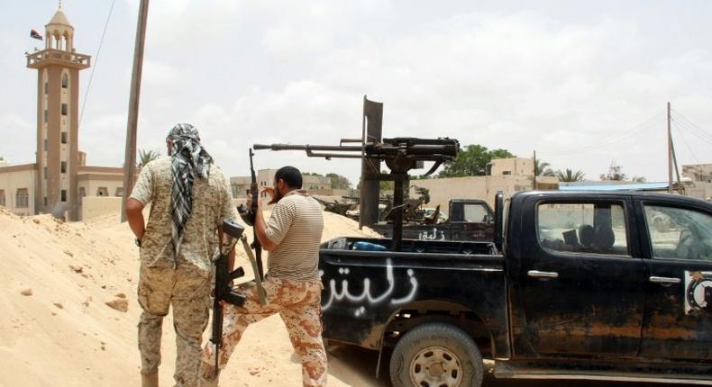 Fighters from the pro-government forces loyal to Libya's Government of National Unity (GNA) hold a position as they target the Islamic State (IS) group in Sirte on June 23, 2016