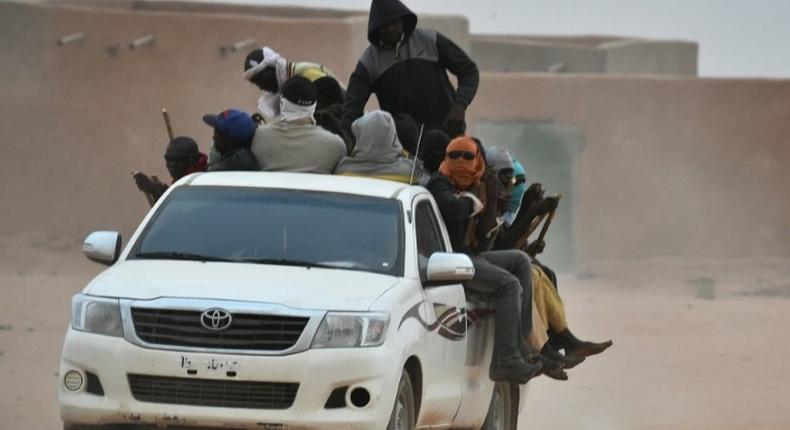 A vehicle carrying migrants travels through Agadez, Niger, en route to Libya in June 2015