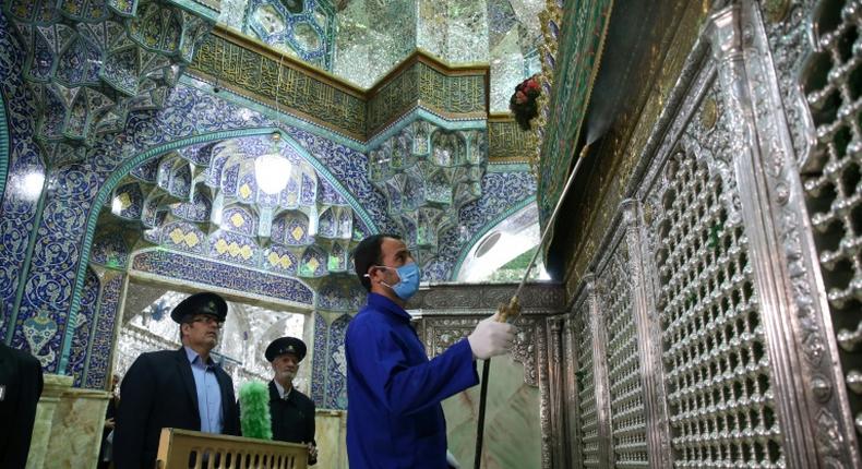 Iranian sanitary workers disinfect the Masumeh shrine in the Shiite holy city of Qom, where a prominent local member of parliament is among the latest people infected with the coronavirus