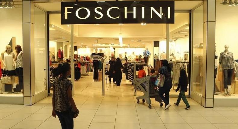 A shopper walks past a Foschini store at a shopping centre in Lenasia, south of Johannesburg, August 28, 2013. REUTERS/Siphiwe Sibeko