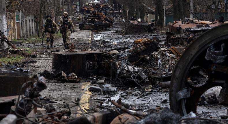 Soldiers walk amid destroyed Russian tanks in Bucha, in the outskirts of Kyiv, Ukraine, April 3, 2022.AP Photo/Rodrigo Abd, File