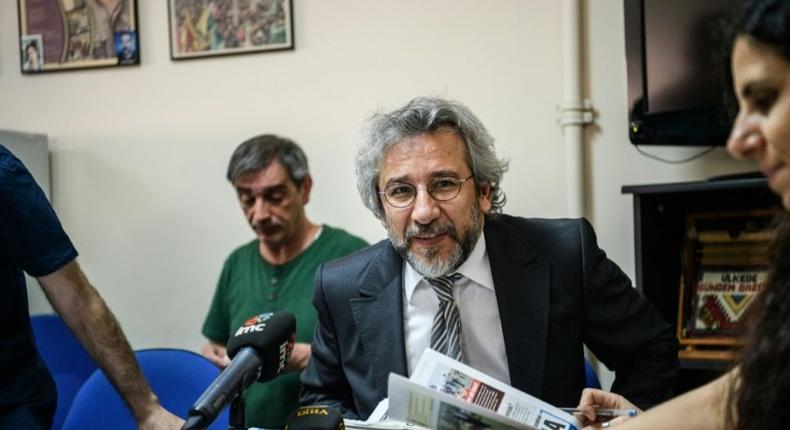 Cumhuriyet Daily newspaper Editor-in-chief Can Dundar (C), pictured during a meeting in 2016, was handed a five-year-and-10-month jail term and has now fled Turkey for Germany
