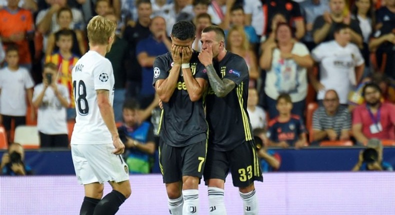 Ronaldo was consoled by his teammates after being sent off in the first half of his Champions League debut for Juve