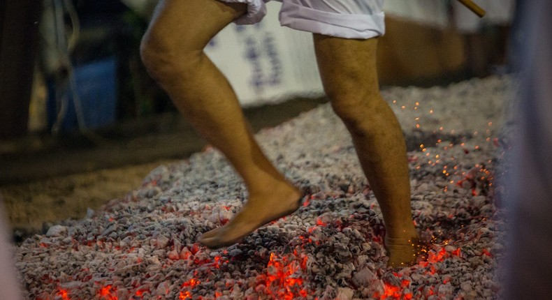 A man walks over hot coals in Thailand.