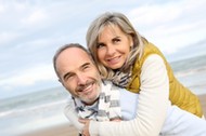 Senior man giving piggyback ride to wife