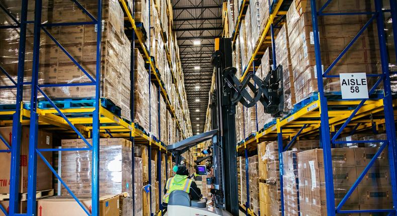 A forklift operator moves through a Lineage Logistics cold storage warehouse.Lineage Logistics