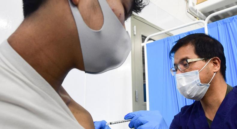 Registered Nurse Robert Orallo administers the Pfizer Covid-19 vaccine at the Blood Bank of Alaska in Anchorage on March 19, 2021.
