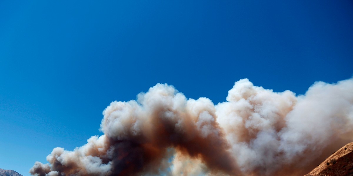 A huge plume of smoke crosses over Interstate 15 during the Blue Cut fire at the Cajon Pass in San Bernardino County, California.