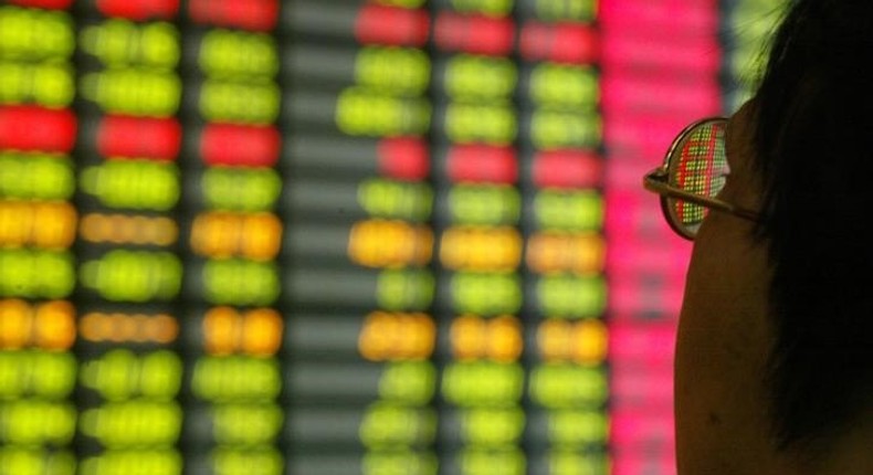 A Chinese investor monitors share prices at a securities company in Shanghai, file. 