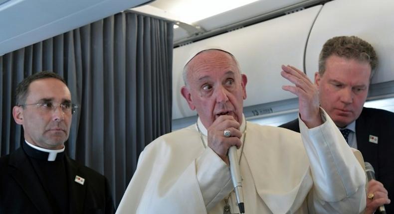 Pope Francis addresses reporters during his flight back to Rome following a two-day visit at Fatima in Portugal