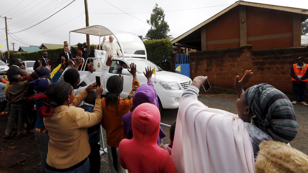 Pope Francis waves as he arrives at the Kangemi slums on the outskirts of Kenya's capital Nairobi