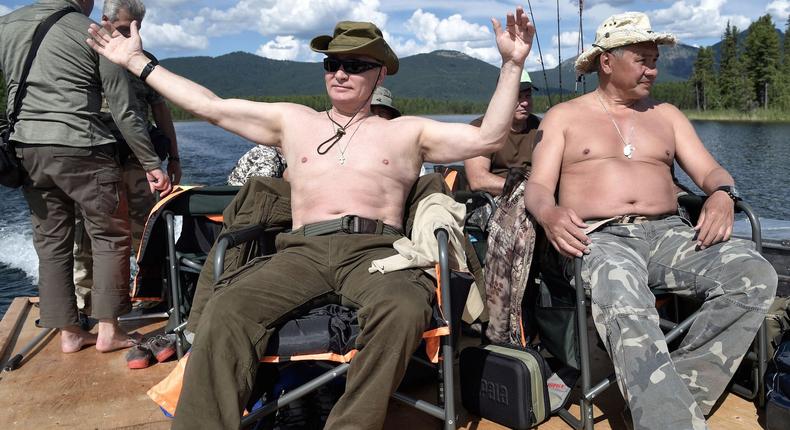 Russian President Vladimir Putin and Defence Minister Sergei Shoigu rest after fishing during the hunting and fishing trip which took place on August 1-3 in the republic of Tyva in southern Siberia, Russia, in this photo released by the Kremlin on August 5, 2017.