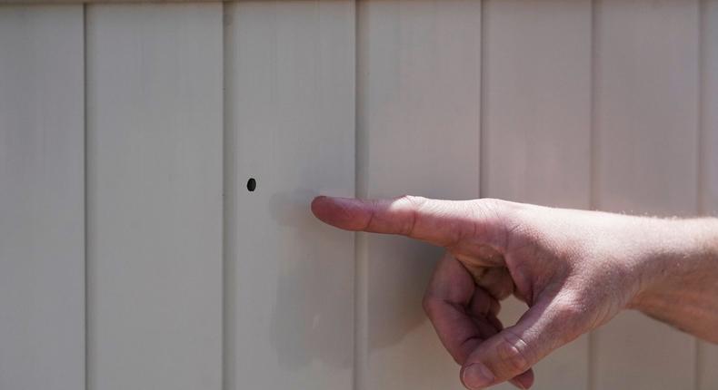 Lane Mugleston, the owner of Leap Ahead Daycare, points to a bullet hole as he speaks to reporters Tuesday, May 23, 2023, in Spanish Fork, Utah.Rick Bowmer/Associated Press