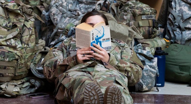 A member of the National Guard reading Atlas Shrugged in the Capitol as the House debated impeachment against President Trump in January 2021.
