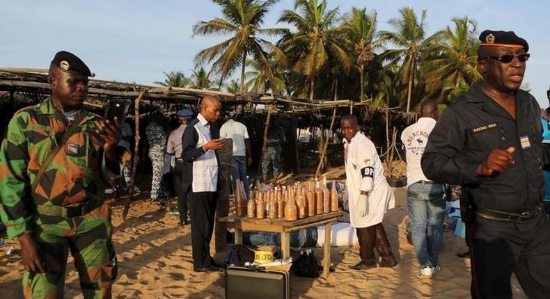 Emergency workers and security officers gather on the beach after an attack in Grand Bassam, Ivory Coast, March 13, 2016. REUTERS/Joe Penney