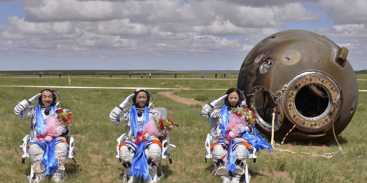 Astronauts Zhang Xiaoguang, Nie Haisheng, and Wang Yaping salute after returning to Earth in China's Shenzhou 10 spacecraft on June 26, 2013, after successfully docking with a crewed space laboratory.