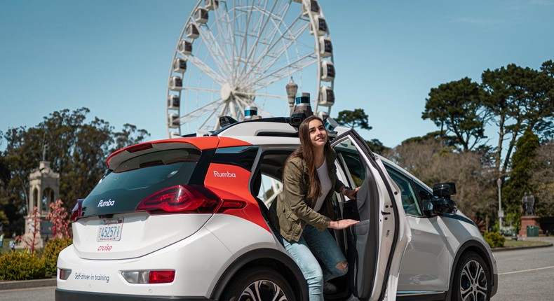 A passenger leaves a driverless Cruise taxi.