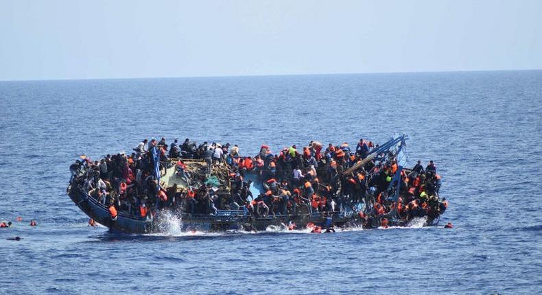 Migrants are seen on a capsizing boat before a rescue operation by Italian navy ships Bettica and Bergamini (unseen) off the coast of Libya in this handout picture released by the Italian Marina Militare on May 25, 2016. 