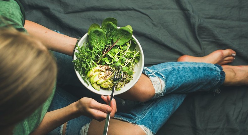 spinach sprouts avocado woman eating healthy salad