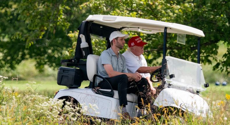 Former President Donald Trump drives a cart at Trump National Golf Club with his son Eric Trump at left, Monday, Sept. 12, 2022, in Sterling, Va.Alex Brandon/AP