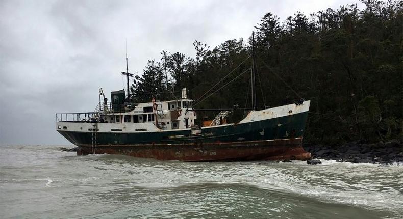 A vessel sits on the rocks after running aground near the Whitsunday Islands during Cyclone Debbie