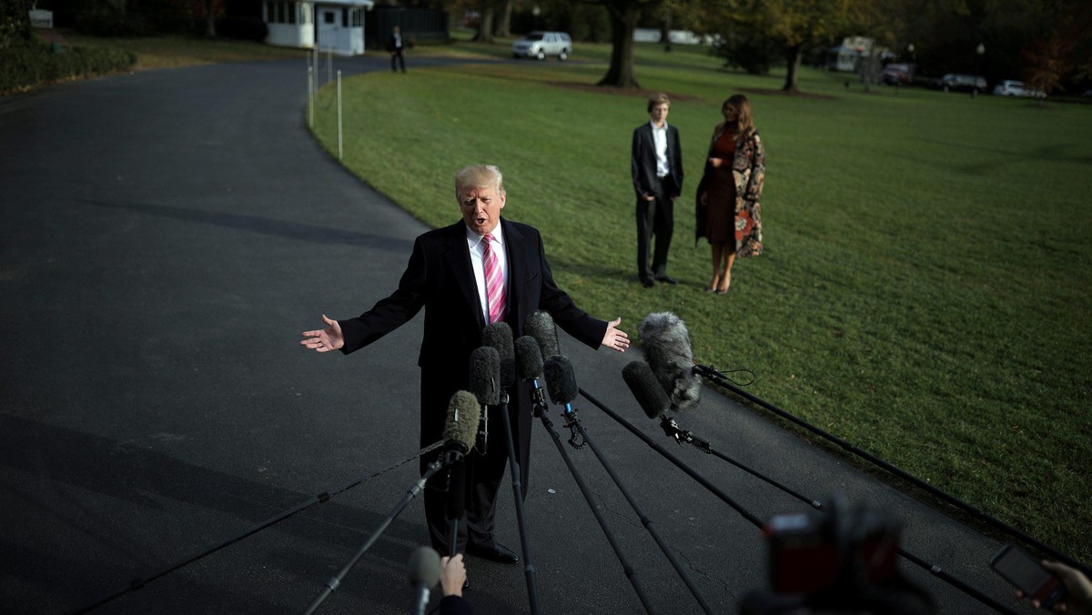 U.S. President Donald Trump talks with the reporters as First Lady Melania Trump and her son Barron 