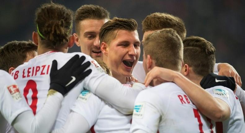 Leipzig's defender Willi Orban celebrates with teamates after scoring his team's third goal against Hertha BSC Berlin in Leipzig, eastern Germany on December 17, 2016