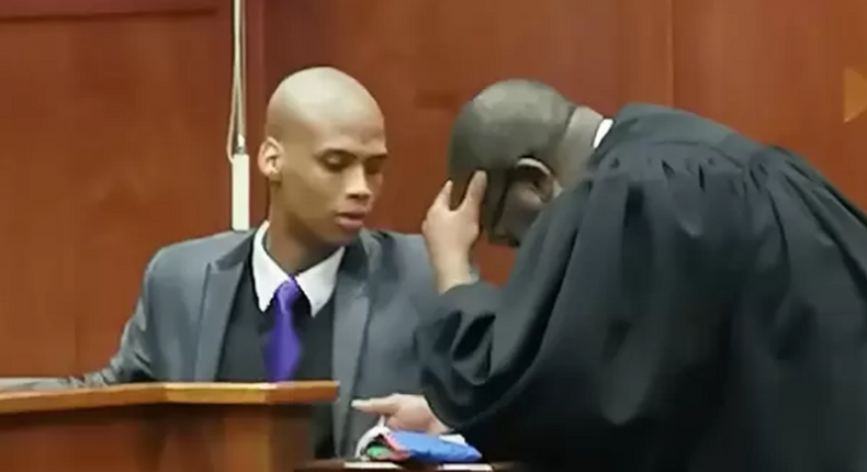 A Durban High Court in South Africa found 24-year-old policeman, Austin Reynold (pictured talking to his attorney), guilty of killing a suspected Nigerian drug dealer [iol.co.za]