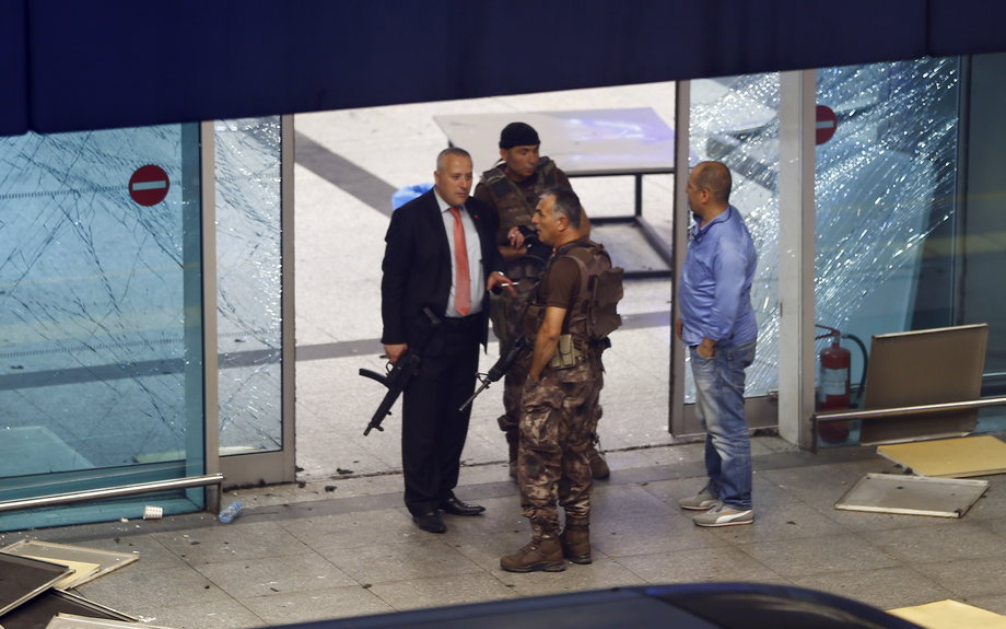Armed security stand at an entrance of Turkey's largest airport, Istanbul Ataturk, after a blast on June 28.
