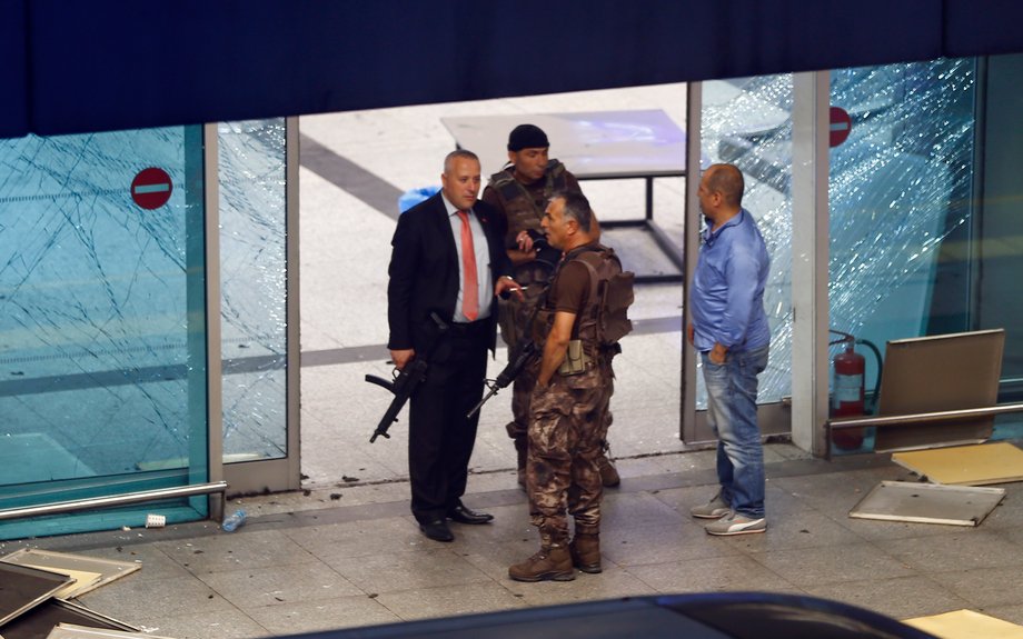 Armed security stand at an entrance of Turkey's largest airport, Istanbul Ataturk, after a blast on June 28.