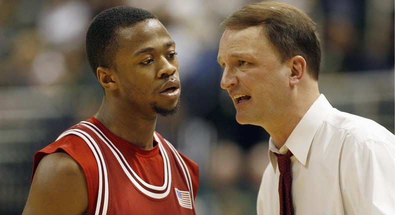 Dan Dakich (right) speaks with a player while serving as Indiana's interim head coach in 2008.