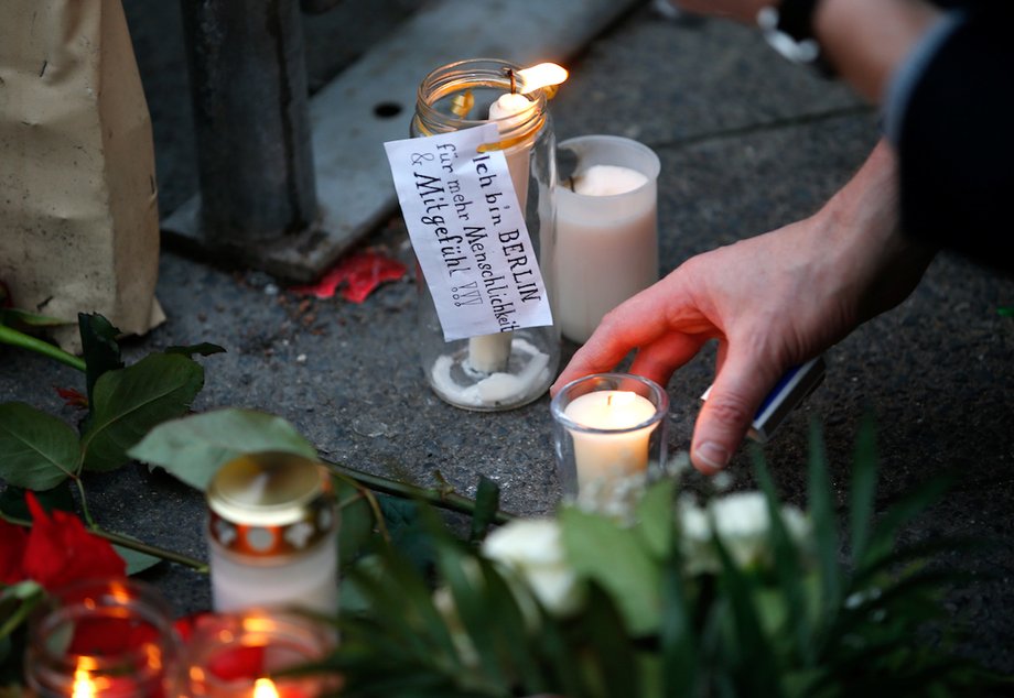 A candle seen Tuesday in Berlin with a sticker saying "I am Berlin — For more humanity and compassion."