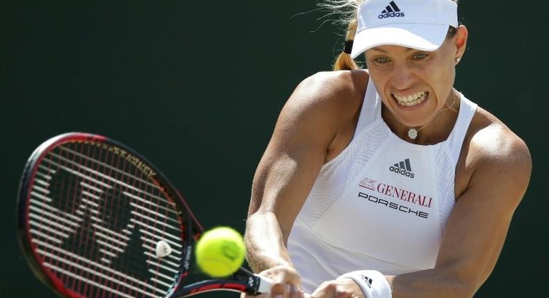 Germany's Angelique Kerber returns against Spain's Garbine Muguruza during their women's singles match during the 2017 Wimbledon Championships in Wimbledon, southwest London, on July 10, 2017