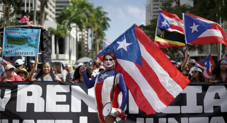 People march in San Juan, Puerto Rico on July 25, 2019, one day after the resignation of Governor Ricardo Rossello