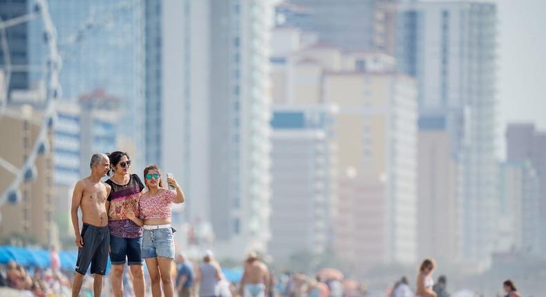 People take a photo in May 2021 in Myrtle Beach, South Carolina, which has one of the fastest job growth rates in the country.Sean Rayford/Getty Images