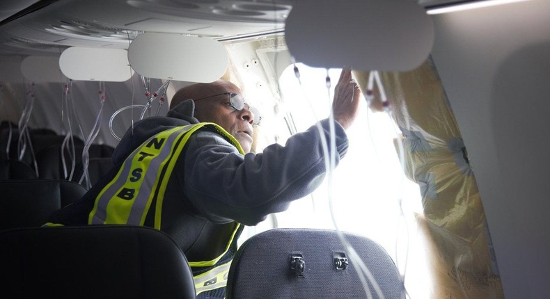 Investigator-in-charge John Lovell examines the area where the plane's door plug had been.National Transportation Safety Board