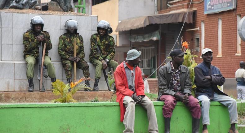 Ant-riot police and members of the public at a street in Kisii town