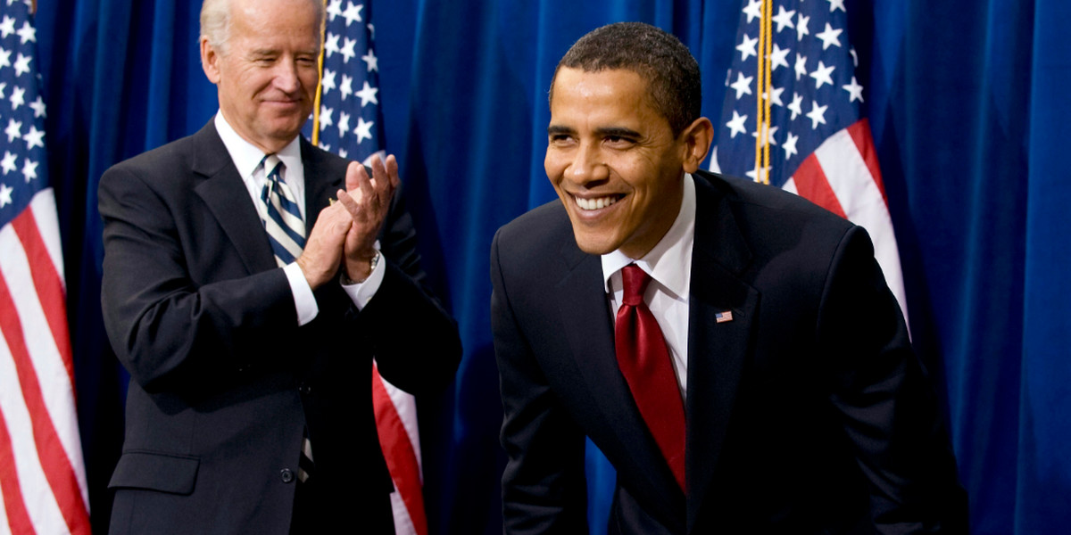 Barack Obama smiles after he signed the American Recovery and Reinvestment Act next to Vice President Joseph Biden.