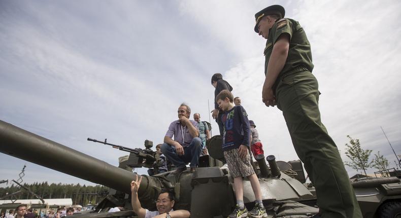 Visitors climb atop Russian tanks and military vehicles on display at Patriot Park.Nikita Shvetsov/Anadolu Agency/Getty Images