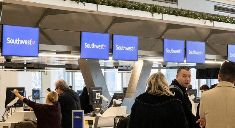 Passengers wait in line to check in for their flights at Southwest Airlines service desk at LaGuardia Airport, Tuesday, Dec. 27, 2022, in New York.Yuki Iwamura/AP