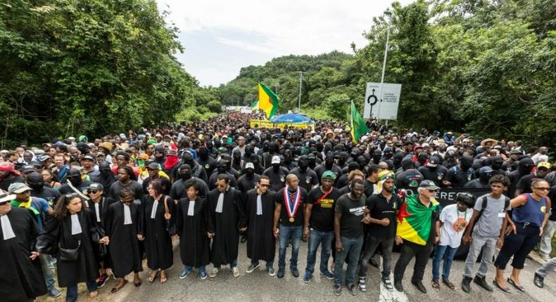 Demonstrators and lawyers stand during a protest over security and the state of the economy near the Centre Spatial Guyanais on April 4, 2017 in Kourou, French Guiana