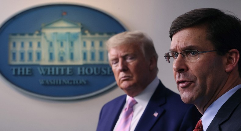 Then-Secretary of Defense Mark Esper speaks as then-President Donald Trump listens during a daily White House coronavirus press briefing on April 1, 2020.
