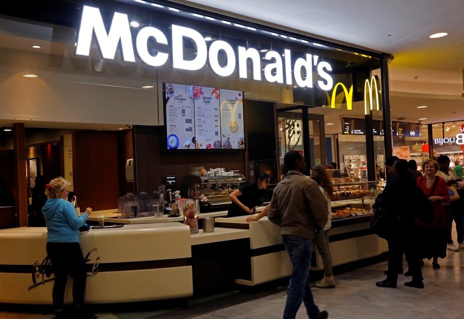 Customers placing orders at a McDonald's in a shopping mall.