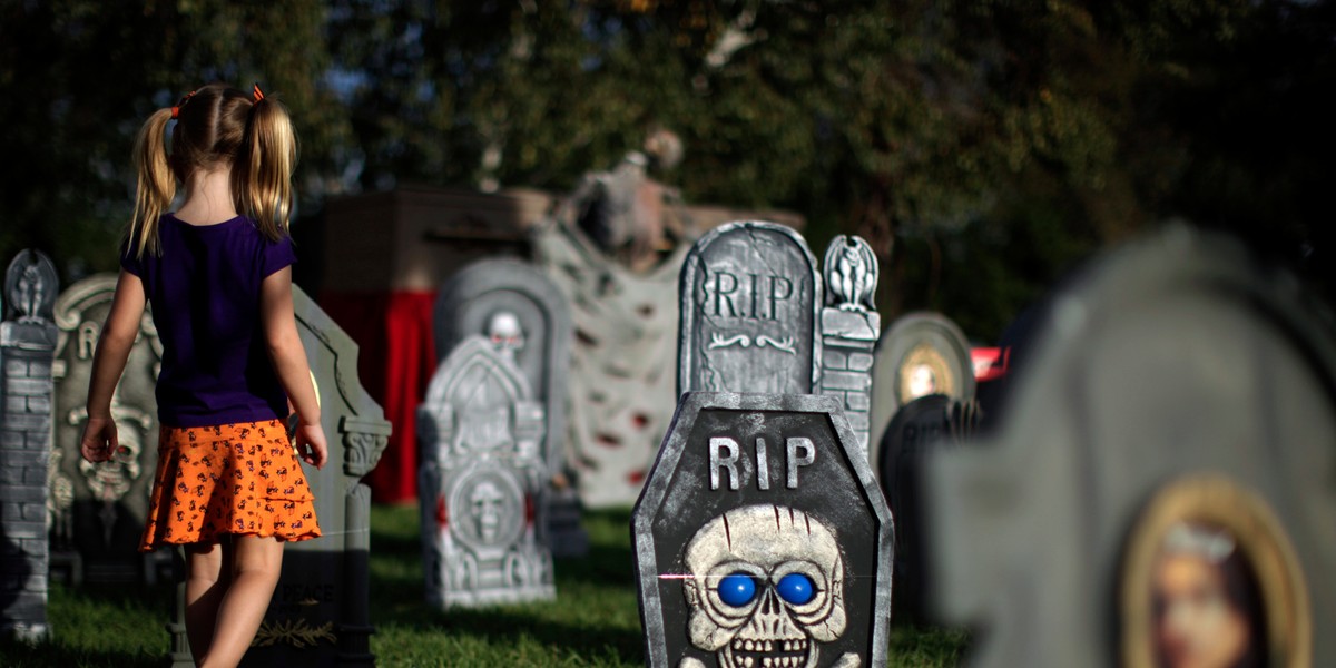 Cadence Cirlin, 3, plays in the garden of a home decorated for Halloween in Los Angeles.