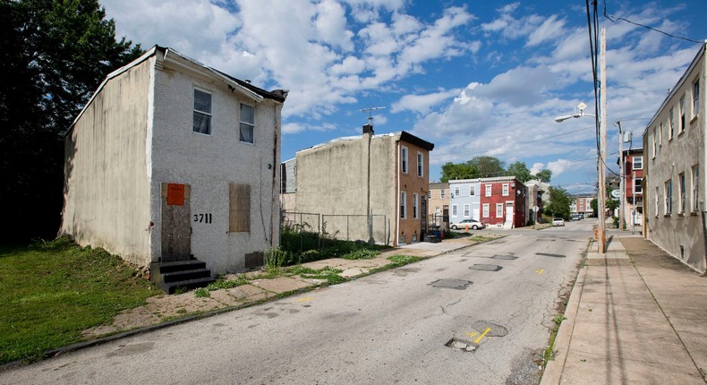 An abandoned home, left, in the impoverished Mantua section of Philadelphia, May 23, 2014.