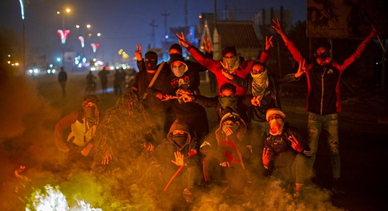 Iraqi anti-government protesters at a makeshift roadblock in the southern city of Basra