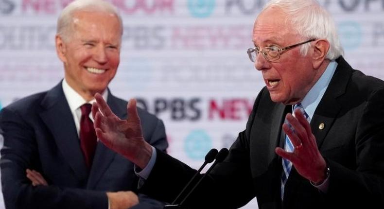 FILE PHOTO: Former Vice President Joe Biden laughs as Senator Bernie Sanders speaks at the 2020 Democratic campaign debate at Loyola Marymount University in Los Angeles, California, U.S., December 19, 2019. REUTERS/Mike Blake/File Photo