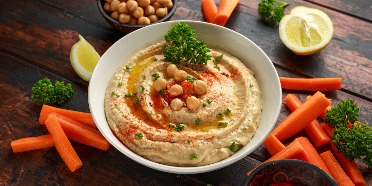 Hummus with olive oil, paprika, lemon and carrot.