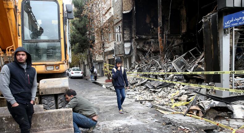 FILE PHOTO: People walk near a burnt bank, after protests against increased fuel prices, in Tehran, Iran November 20, 2019. Picture taken November 20, 2019. Nazanin Tabatabaee/WANA (West Asia News Agency) via REUTERS/File Photo