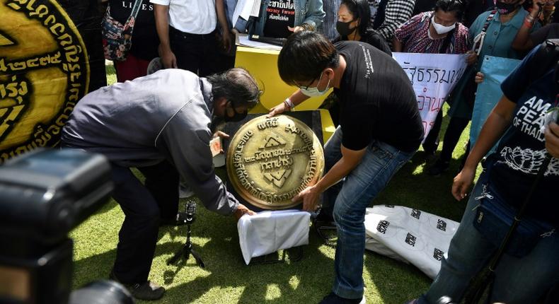 Thai activists unveil a replica of bronze plaque marking the anniversary of the 1932 revolution. The original mysteriously vanished in 2017